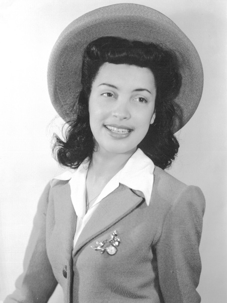 Photo of a 20-year-old Betty wearing a hat and suit.